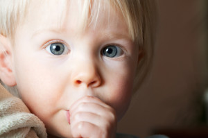 Young child sucking her thumb.